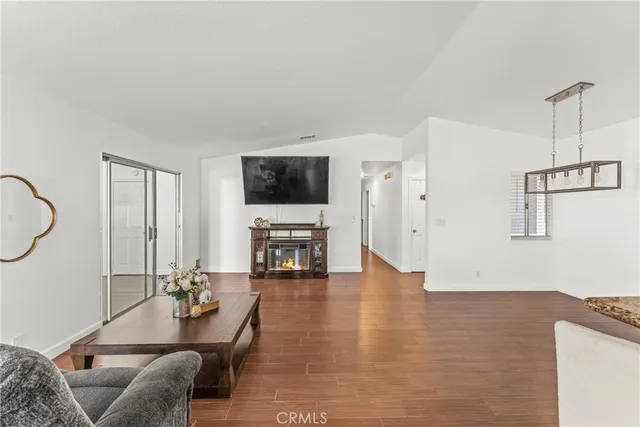 a living room with lots of furniture and kitchen view