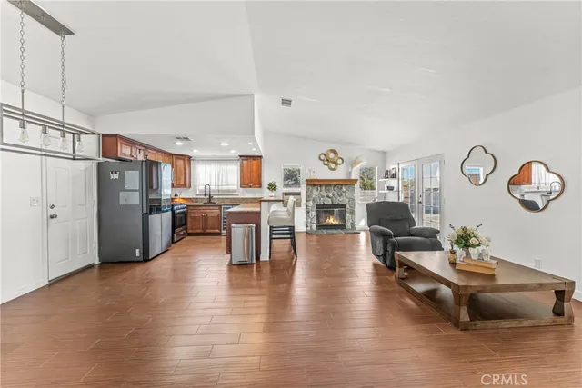 a living room with furniture a fireplace and a flat screen tv