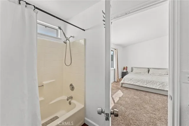 a living room with a bed furniture and a window