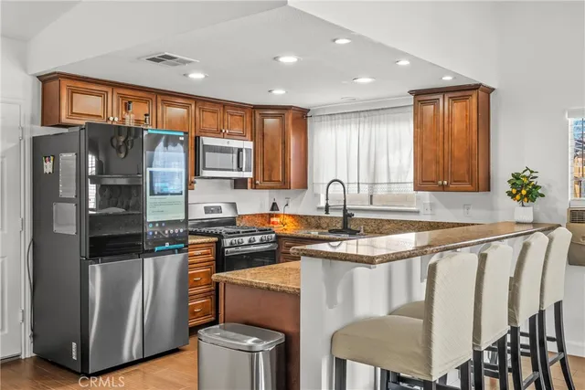 a kitchen with granite countertop a stove and a sink
