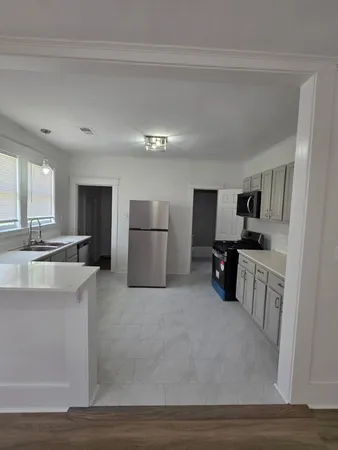 a view of kitchen with refrigerator stove and microwave