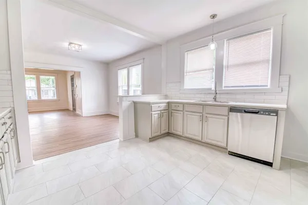 a view of a kitchen with microwave and cabinets