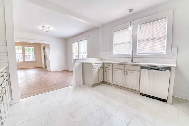 a view of a kitchen with microwave and cabinets