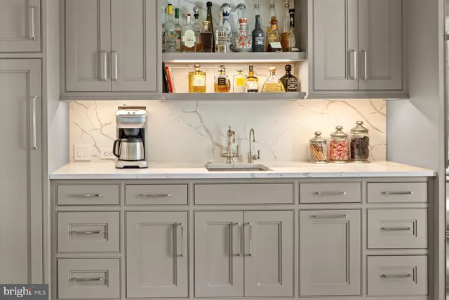 a kitchen with white cabinets and a wooden floor