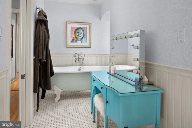 a spacious bedroom with a bed and a large window