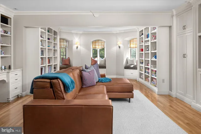 a view of living room with furniture and book shelf