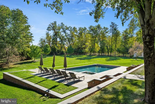 a view of a backyard with a patio and swimming pool