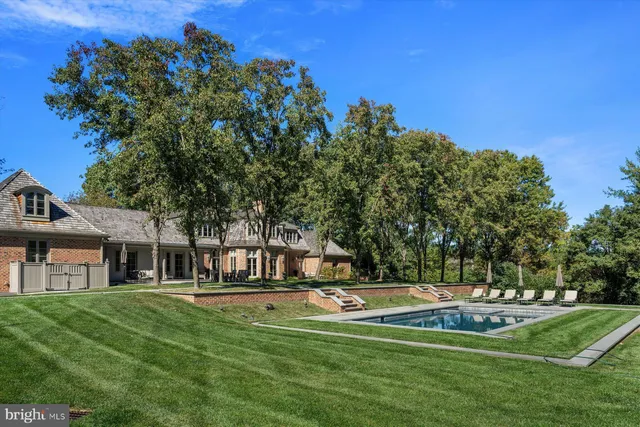 a view of a tennis ground with large trees