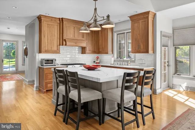a dining room with a wooden table and chairs