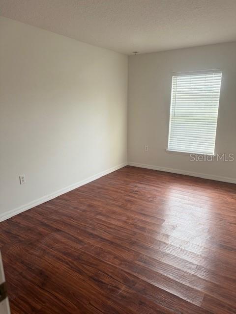 386 Haversham Road Deltona, FL 32725 - Photo 15 of 39 a view of an empty room with wooden floor and a window