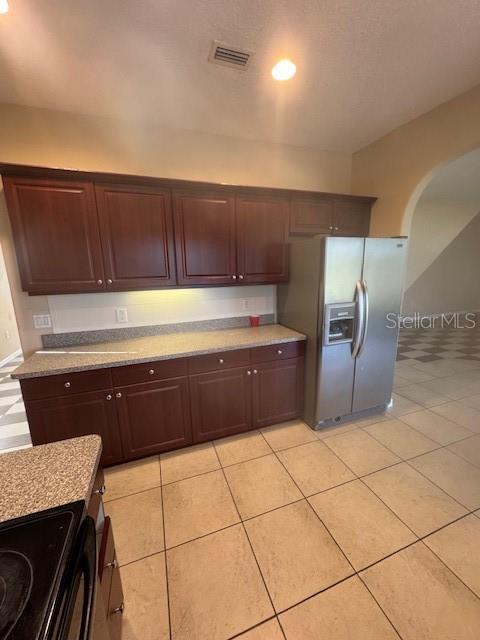 386 Haversham Road Deltona, FL 32725 - Photo 22 of 39 a kitchen with granite countertop a refrigerator and a stove top oven