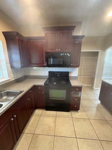 386 Haversham Road Deltona, FL 32725 - Photo 23 of 39 a kitchen with a sink and a stove top oven