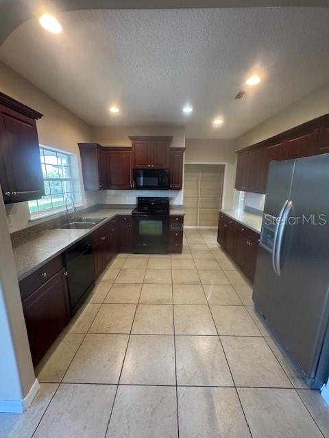 386 Haversham Road Deltona, FL 32725 - Photo 28 of 39 a kitchen with stainless steel appliances a refrigerator sink and cabinets