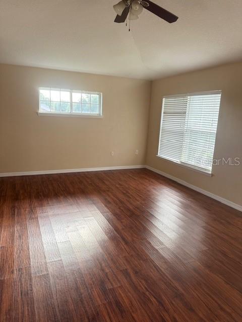 386 Haversham Road Deltona, FL 32725 - Photo 8 of 39 an empty room with wooden floor and windows