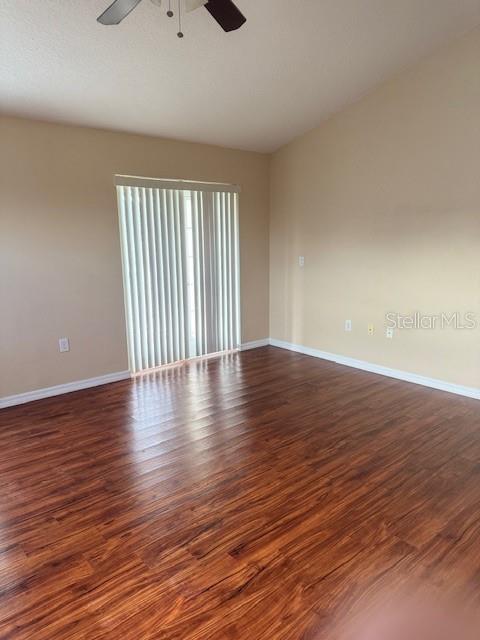 386 Haversham Road Deltona, FL 32725 - Photo 9 of 39 a view of an empty room with wooden floor and a window