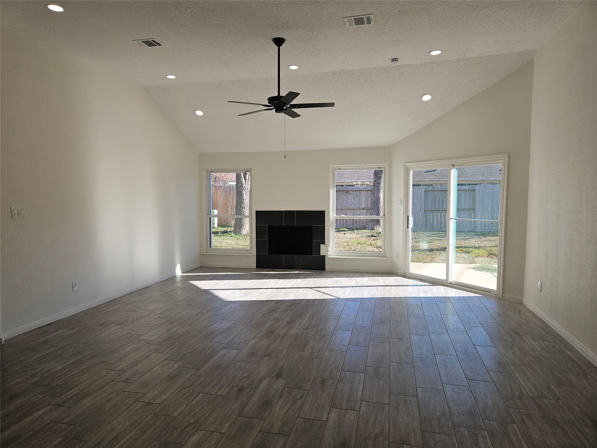 4426 Waterfall Way Sugar Land, TX 77479 - Photo 4 of 11 an empty room with wooden floor fireplace and windows