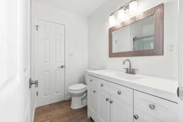 a view of bathroom with a sink mirror and toilet