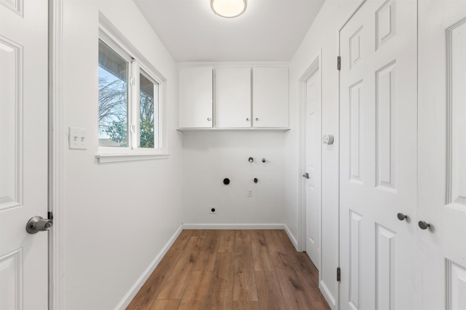 1713 Wolverine Way Modesto, CA 95355 - Photo 17 of 28 a view of a room with wooden floor and white walls