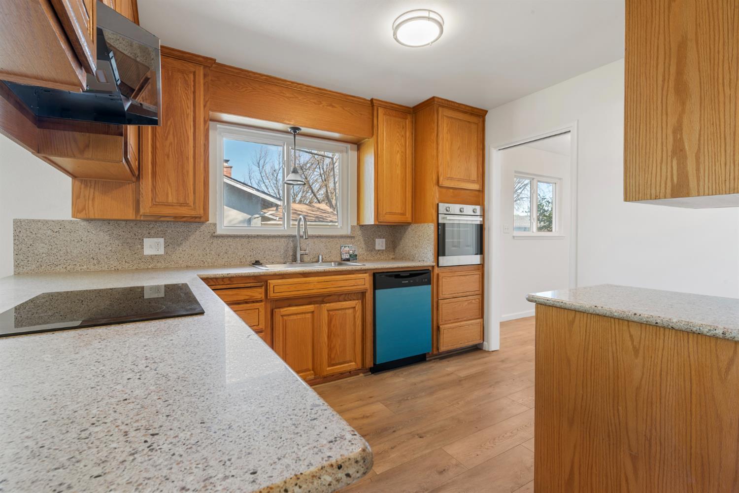 1713 Wolverine Way Modesto, CA 95355 - Photo 4 of 28 a kitchen with stainless steel appliances granite countertop a sink and a refrigerator
