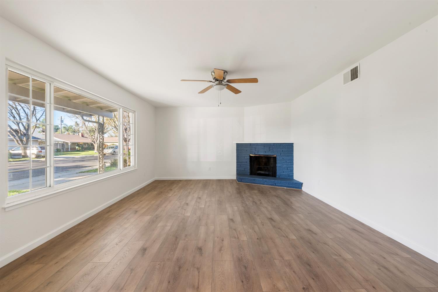 1713 Wolverine Way Modesto, CA 95355 - Photo 8 of 28 wooden floor in an empty room with a window
