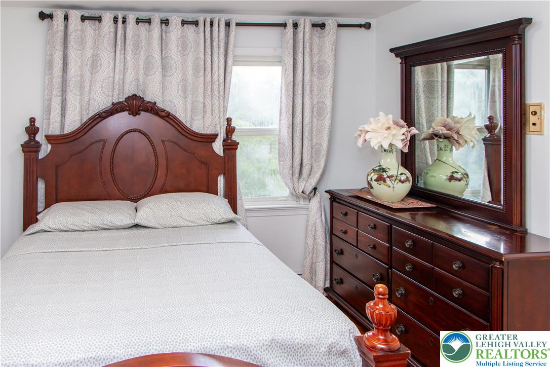 3582 Country Club Road Easton, PA 18045 - Photo 26 of 48 Elegant wooden furnishings and soft window treatments create a serene sleeping environment.