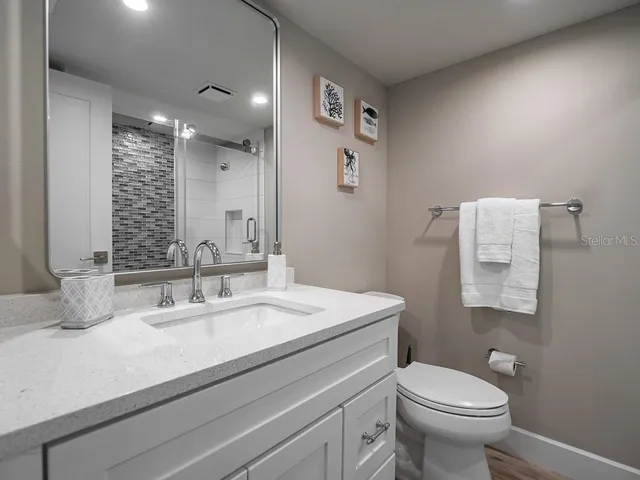 a bed room with a bed and a night stand