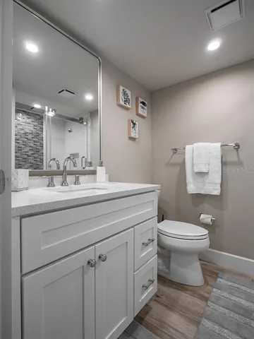 a bathroom with a sink toilet and shower