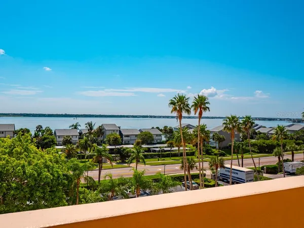 a view of a white house with a yard and table and chairs