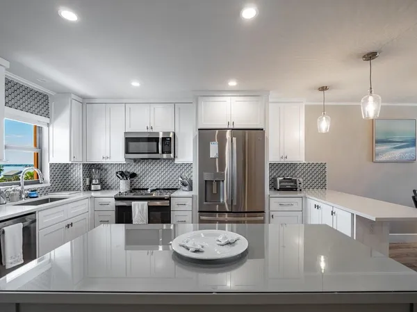 a kitchen with refrigerator and chairs
