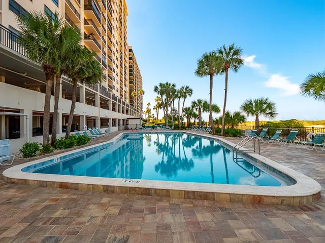a living room with furniture and a mirror