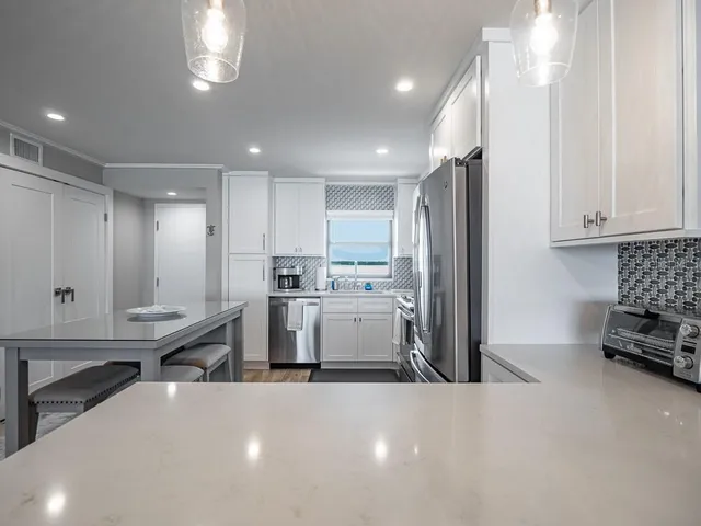 a view of a dining room with furniture a chandelier and wooden floor