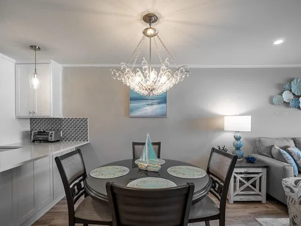 a living room with furniture a flat screen tv and a large window
