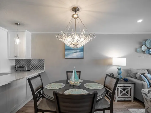 a living room with furniture a flat screen tv and a large window