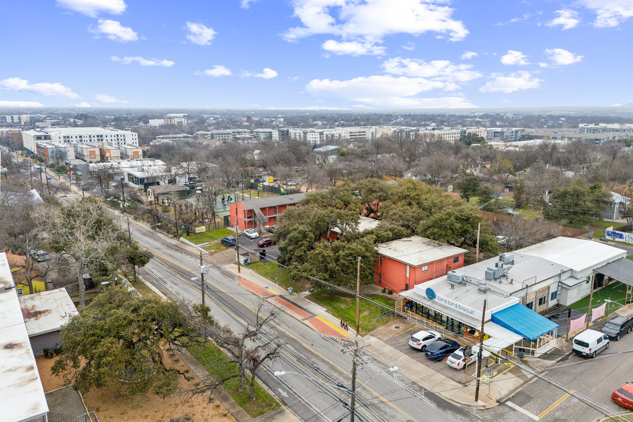 2827 Manor Road, Unit 3104 Austin, TX 78722 - Photo 26 of 30 An aerial perspective reveals the vibrant neighborhood, bustling with activity along the tree-lined streets and showcasing a mix of commercial and residential structures.