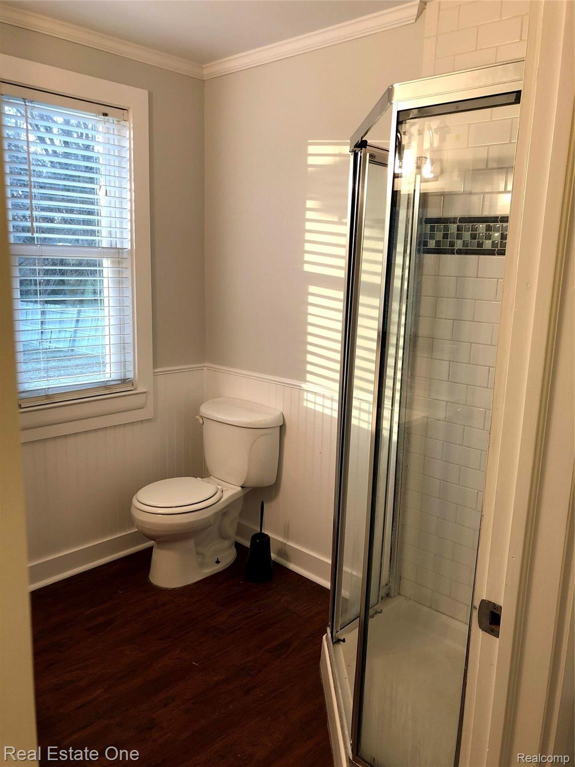 235 Millville Road Lapeer, MI 48446 - Photo 21 of 48 First floor bath between kitchen and office, with vinyl floor, ceramic, subway tile and wainscoting.