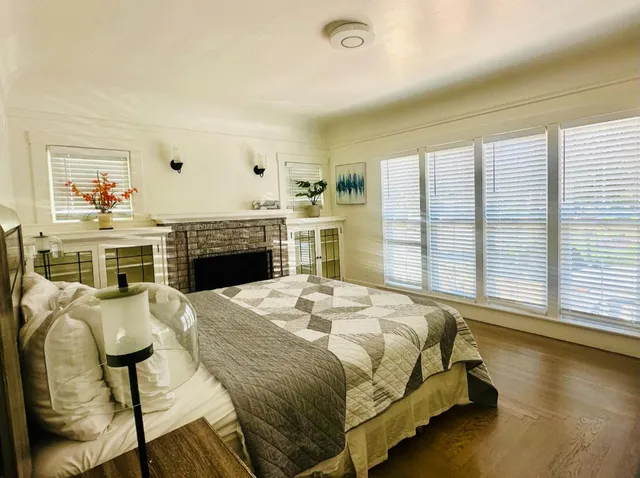 a spacious bedroom with a bed and a fireplace