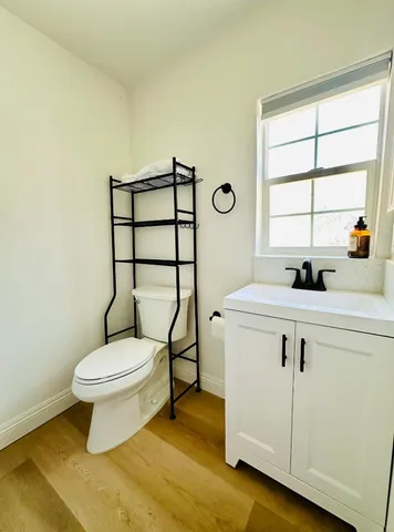 a bathroom with a sink toilet and window