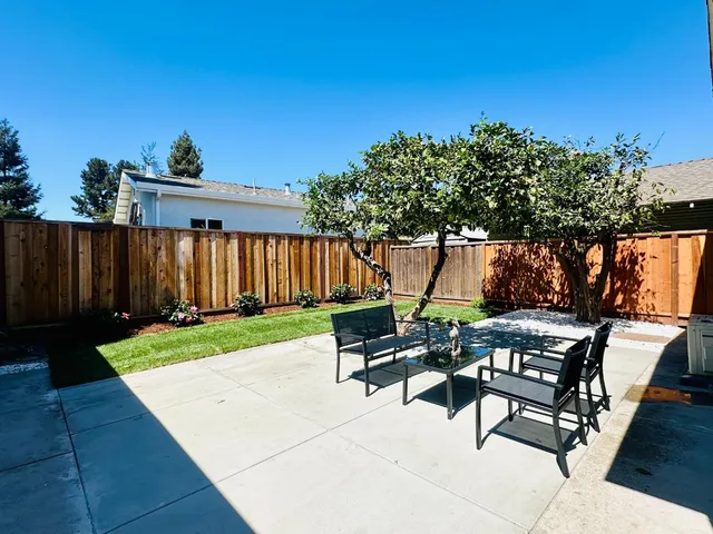 a view of a backyard with sitting area