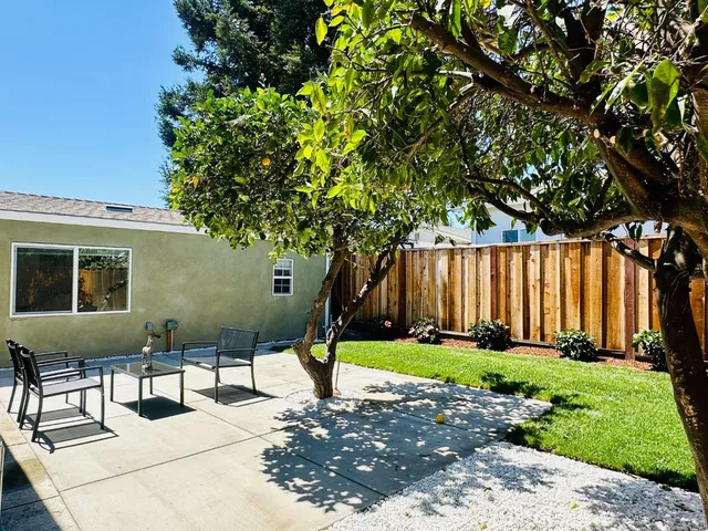 a view of a backyard with sitting area