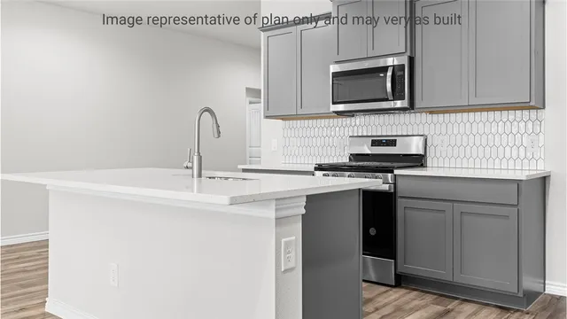 a kitchen with stainless steel appliances a sink stove and cabinets