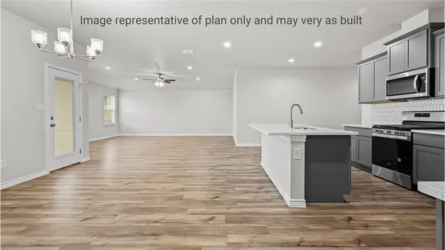 a view of an empty room with a window and a ceiling fan