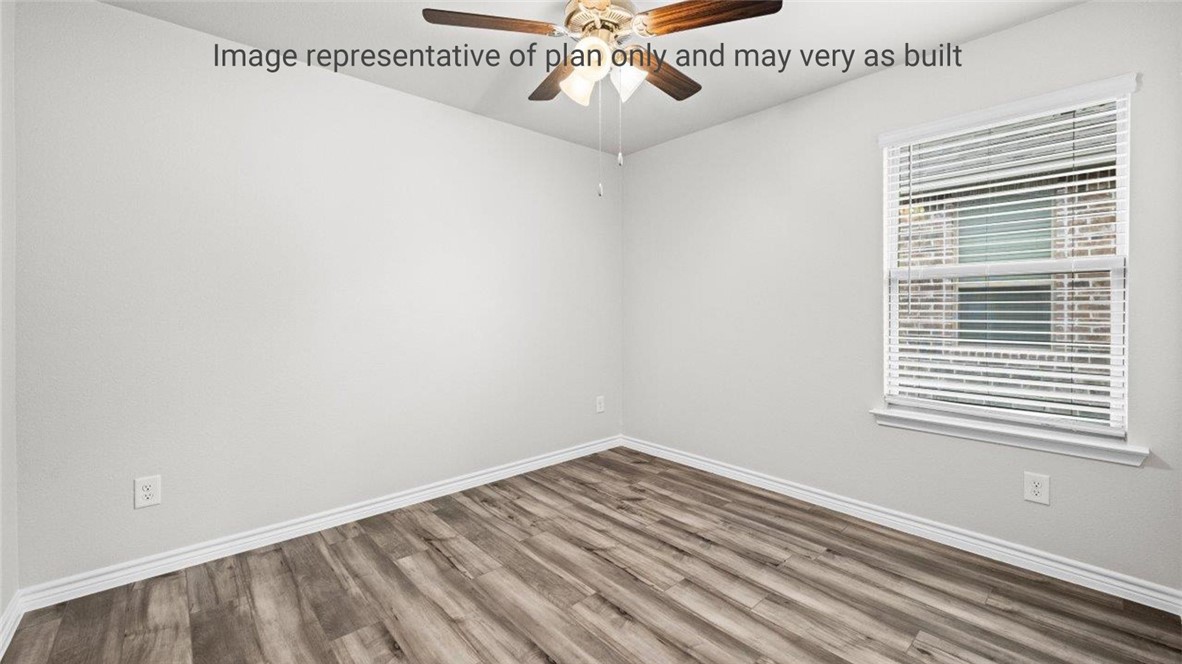1409 Irigoyen Street Corpus Christi, TX 78415 - Photo 25 of 38 a view of an empty room with wooden floor and a window