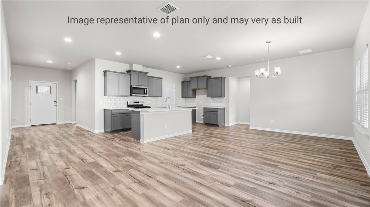 1409 Irigoyen Street Corpus Christi, TX 78415 - Photo 9 of 38 a view of kitchen with kitchen island a sink wooden floor and stainless steel appliances