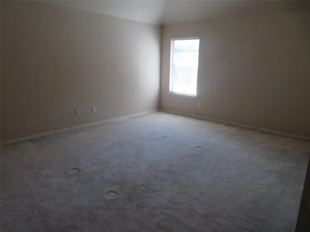 an empty room that has a window in it