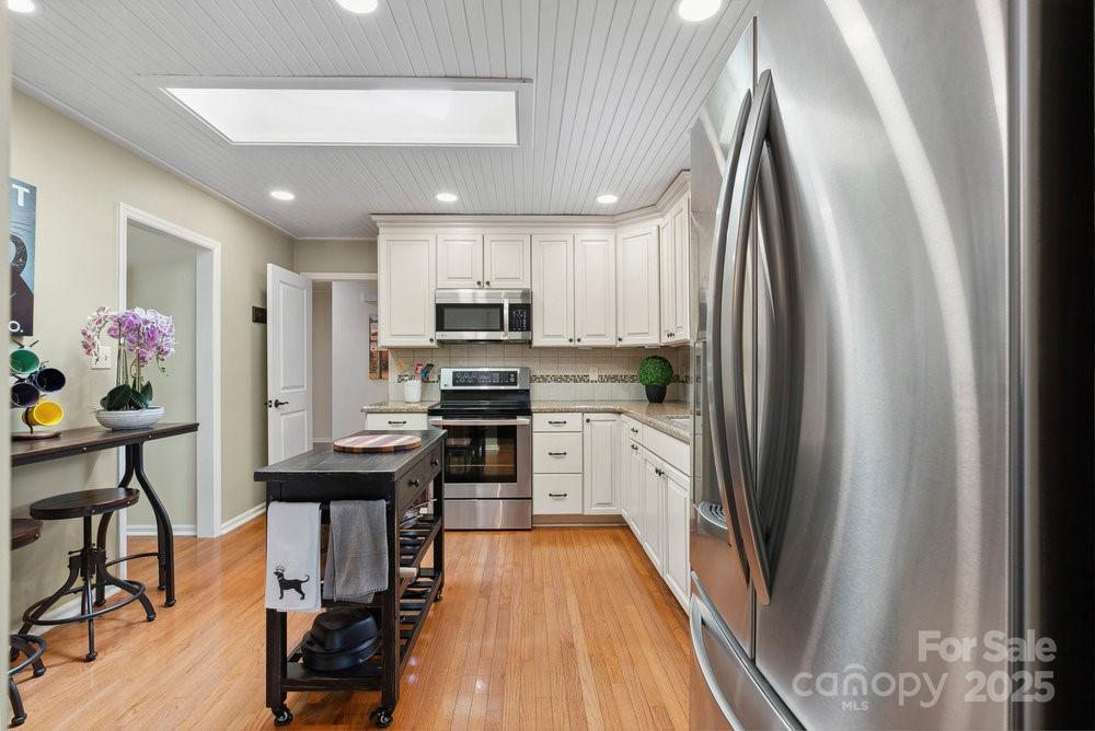 83 Lovers Loop Road Asheville, NC 28803 - Photo 11 of 44 a kitchen with stainless steel appliances a refrigerator and a stove top oven