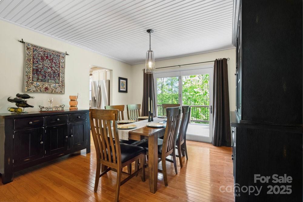 83 Lovers Loop Road Asheville, NC 28803 - Photo 16 of 44 a view of a dining room with furniture window and wooden floor