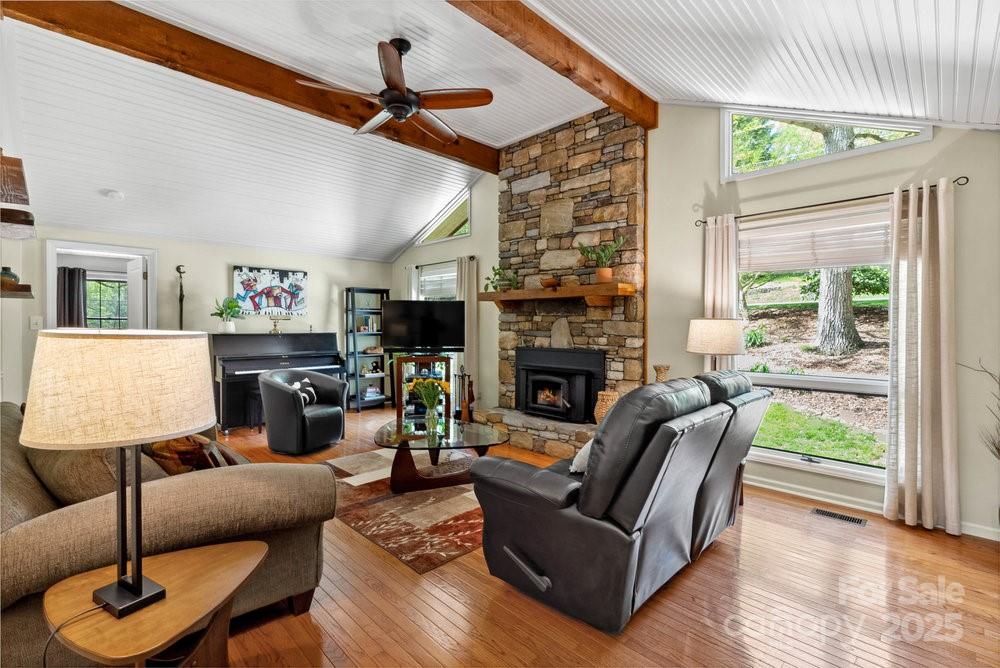 83 Lovers Loop Road Asheville, NC 28803 - Photo 9 of 44 a living room with furniture a fireplace and a window