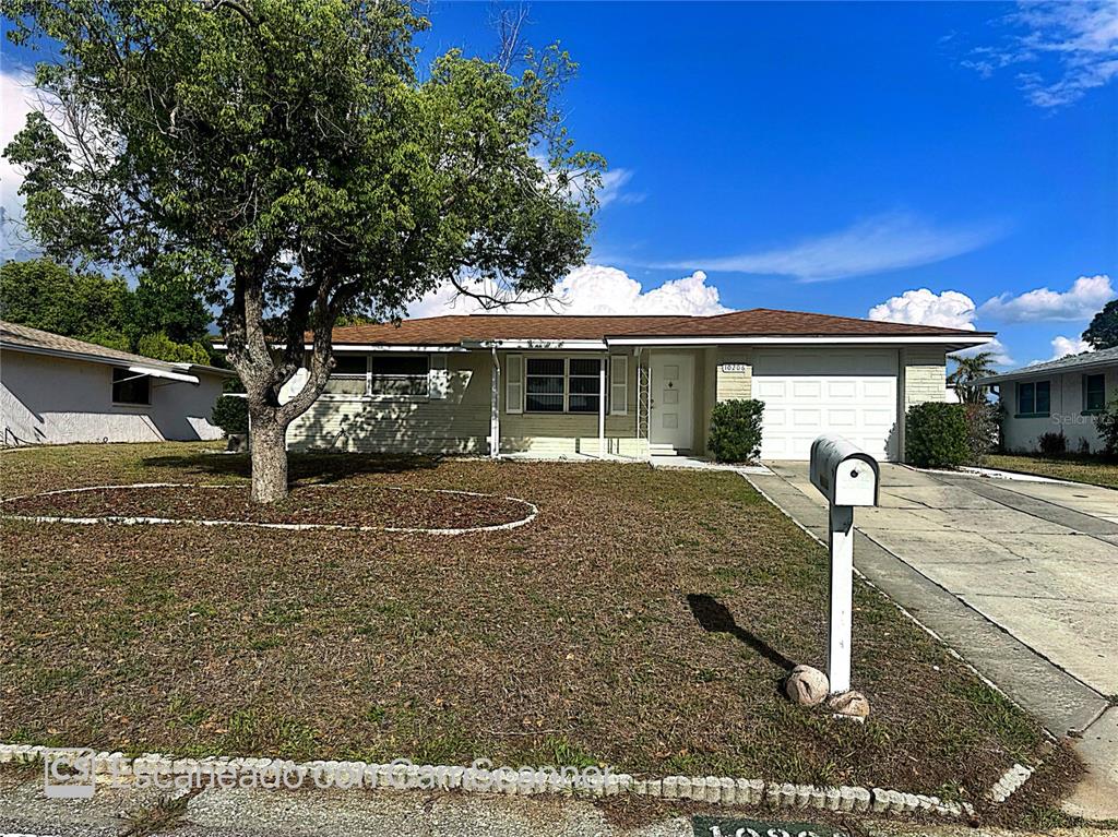 10206 Willow Drive Port Richey, FL 34668 - Photo 1 of 1 a front view of a house with garden