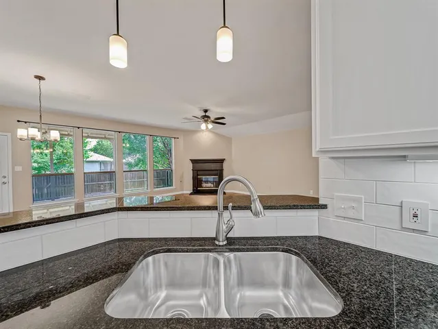 a kitchen with a sink and a window