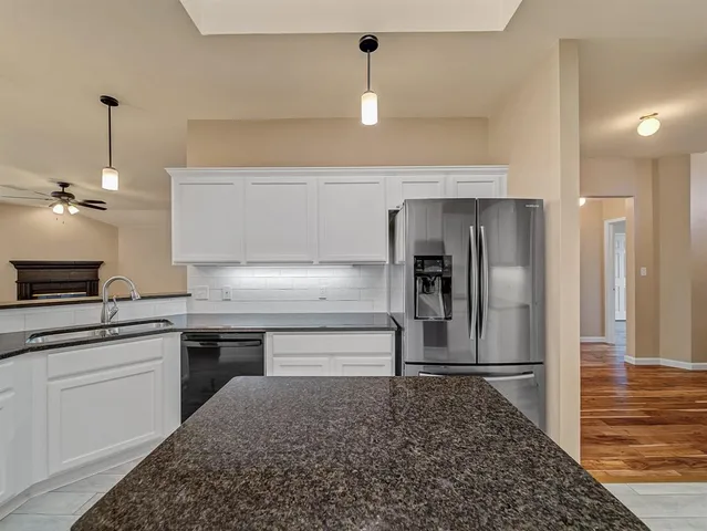 a kitchen with a sink stainless steel appliances and cabinets